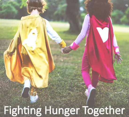 Two children dressed as superheroes with the words Fighting Hunger Together